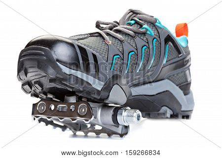 Closeup of cycling shoes with pedal attached to the sole isolated on white background.