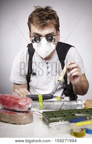 Man making classic type of tube bomb at home