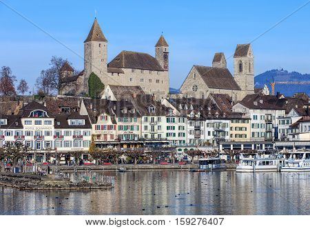 Rapperswil, Switzerland - 30 November, 2016: buildings in the historic part of the town, people on the embankment of Lake Zurich. Rapperswil is a part of the municipality of Rapperswil-Jona in the Swiss Canton of St. Gallen.