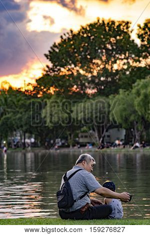 Grandpa And Nephew Relaxing In Chatuchak Park