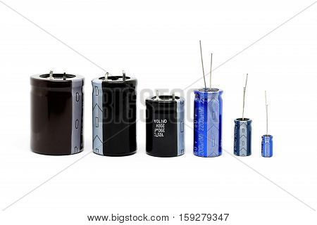 Group of capacitors different sizes isolated on white background.