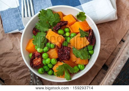 Vegan garnish. Boiled sweet potatoes with green peas cilantro and linseed oil. Perfect for the detox diet or just a healthy meal. Love for a healthy raw food concept.