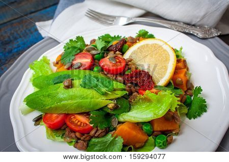 Salad with baked sweet potatoes avocados lentils dried tomatoes cilantro pumpkin seeds and oil. . Perfect for the detox diet or just a healthy meal. Love for a healthy raw food concept.