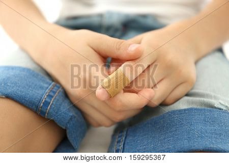 Close up view of little boy's finger with applied sticking plaster