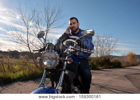 Biker Talking By Phone With His Smarth Phone