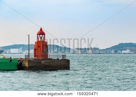 Close up of beautiful retro red stone lighthouse in retro city call mojiko town kita kyushu fukuoka japan.