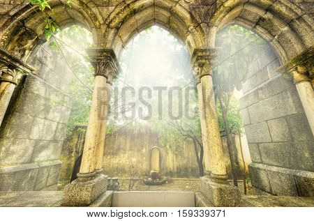 Ancient gothic arches in the myst. Fantasy landscape in Evora Portugal.