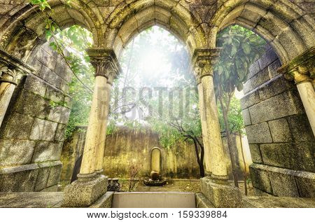 Ancient gothic arches in the myst. Fantasy landscape in Evora Portugal.