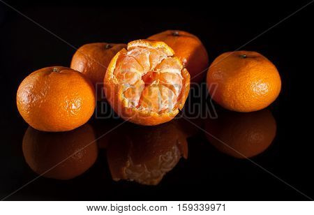 Group Of Mandarins With Reflection On Black Background
