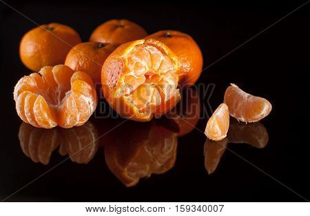Group Of Mandarins With Reflection On Black Background