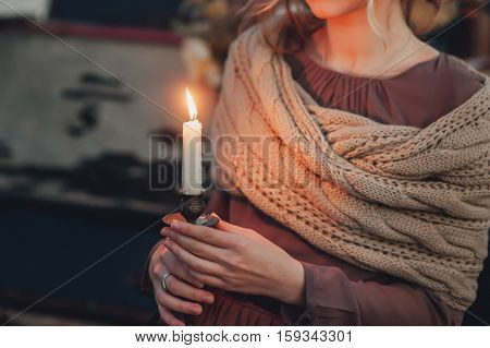 girl holds a candle in his beautiful hands