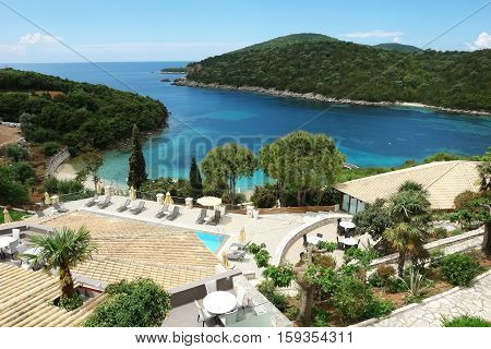 Sivota GREECE May 09 2013: Landscape with sea horizon blue bay green island and beach in Ionian Sea Greece.