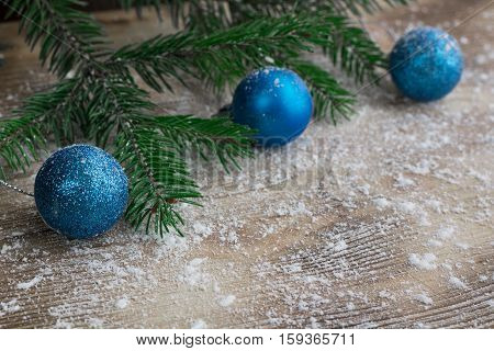 Christmas Tree Branches, Blue Balls On Winter Snowbound Wooden Background