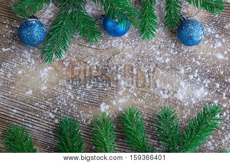 Christmas Tree Branches, Blue Balls On Winter Snow Wooden Background