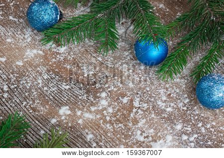 Christmas Tree Branches, Blue Balls On Snowbound Winter Wooden Background