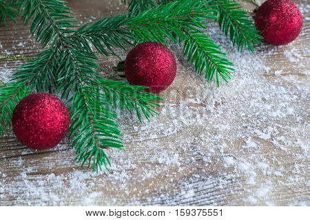 Christmas Tree Branches, Red Balls On Winter Snowbound Wooden Background