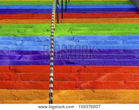 Steps rainbow painted street concrete stairs background.