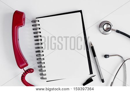 Entry to the doctor blank open notebook with stethoscope top view