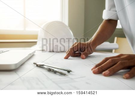 Hands of Engineer working on blueprintConstruction concept. Engineering tools.Vintage tone retro filter effectsoft focus(selective focus)