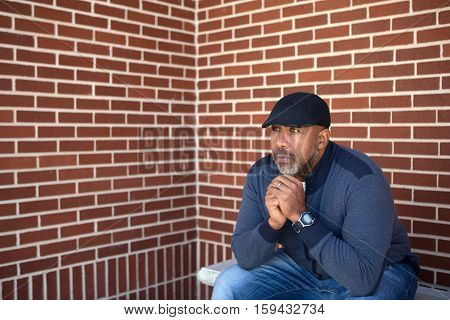 African American man sitting and thinking about life.