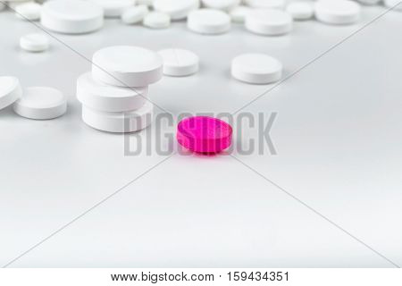 Bunch Of White Tablets. Scattered Pills. Single Pink Pill