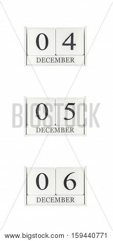 Closeup group of white wooden calendar with black 4 5 6 december word three date calendar isolated on white background
