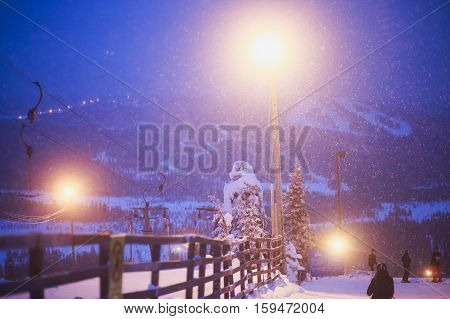 Beautiful cold mountain view of ski resort, winter day with slope, piste and ski lift, evening twilight night picture