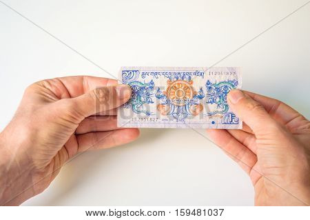 Man Holding One Bhutanese Ngultrum Banknote In His Hands