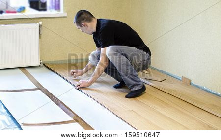 The Process Of Installing Laminate Wooden On The Floor