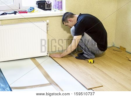 The Process Of Installing Laminate Wooden On The Floor