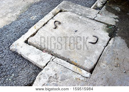 Drain cap made of cement that are eroding.