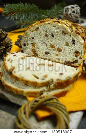 Fresh baked raisins bread sliced on granite board holiday concept
