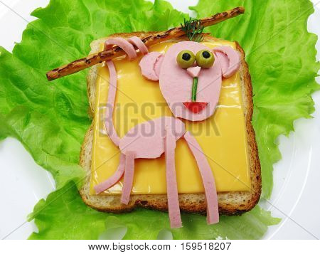 creative sandwich with cheese and salame monkey shape