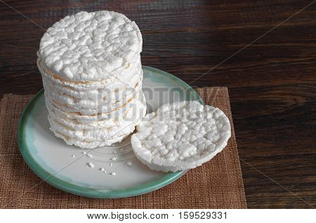 Rice crackers in plate on old wooden table