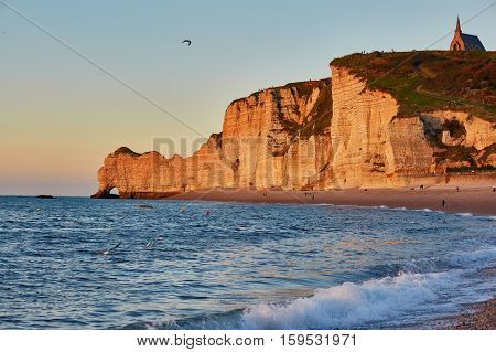 Scenic View Of Etretat With Its Beach And Famous Cliffs