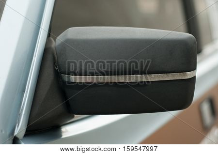Vintage rear-view car mirror. Left side. Black color.