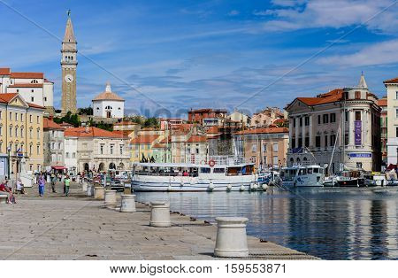 Piran, Slovenia - September 19, 2016: a view of the city of Piran with beautiful old buildings and boats in the Harbor. Piran is one of Slovenia's major tourist attractions.