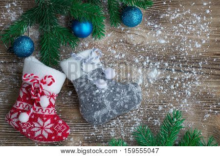 Christmas Stockings On Snowbound Wooden Background With Blue Ball Ornaments
