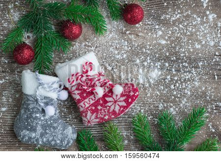 Christmas Stockings On Snowbound Wooden Background With Red Balls Ornaments