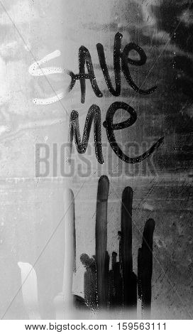Save me with a hand dripping on a fogged glass. Request for help written in water fogged glass.