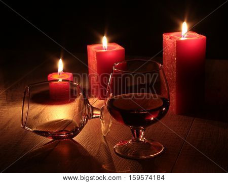 christmas composition photo cognac glass and candle on black background.