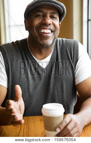 Mature African American sitting in a coffee shop.
