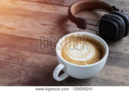 Latte Coffee Cup And Headphone On Table