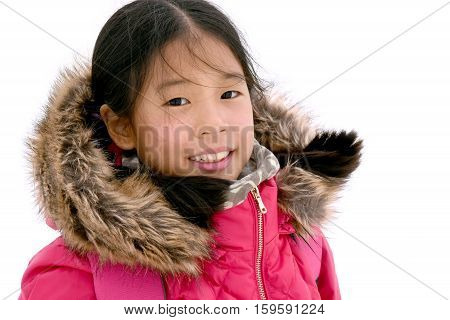 Portrait of young happy Asian girl in pink jacket with furry hood smiling murodo Tateyama Kurobe Alpine Japan. Asian model preteen in shocking pink down jacket Isolated on white background.