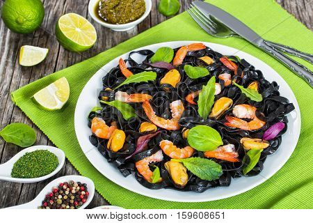 Black Noodles Salad With Prawns, Mussels, Fresh Green Leaves