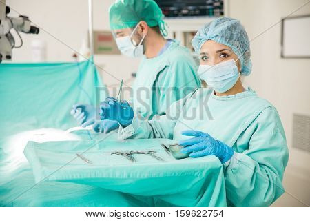 Cute Doctor Handling Instruments In The Or