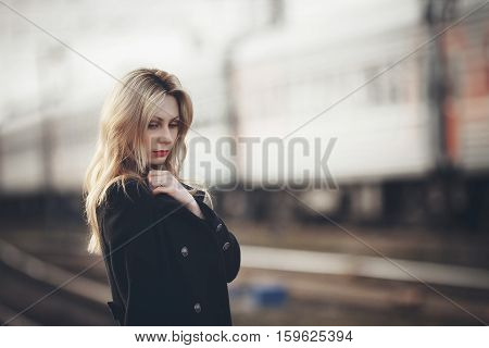 Beautiful Blonde Girl Waiting For The Train At The Station. Romantic, Delicate Look
