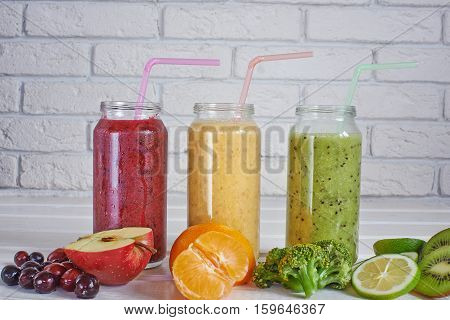Smoothies of kiwi, mandarin, banana, Lemon, apple, currants, berries on a white background