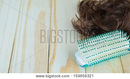 green comb and hair on wooden, Hairbrush on wooden