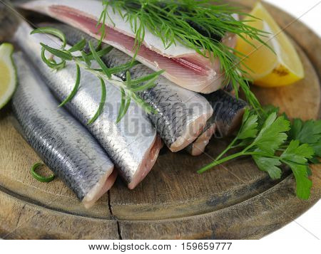 fishes herrings with lemon on a chopping board